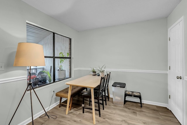 interior space featuring baseboards and wood finished floors