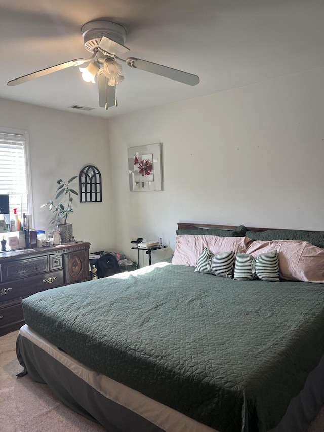 bedroom featuring ceiling fan and light colored carpet