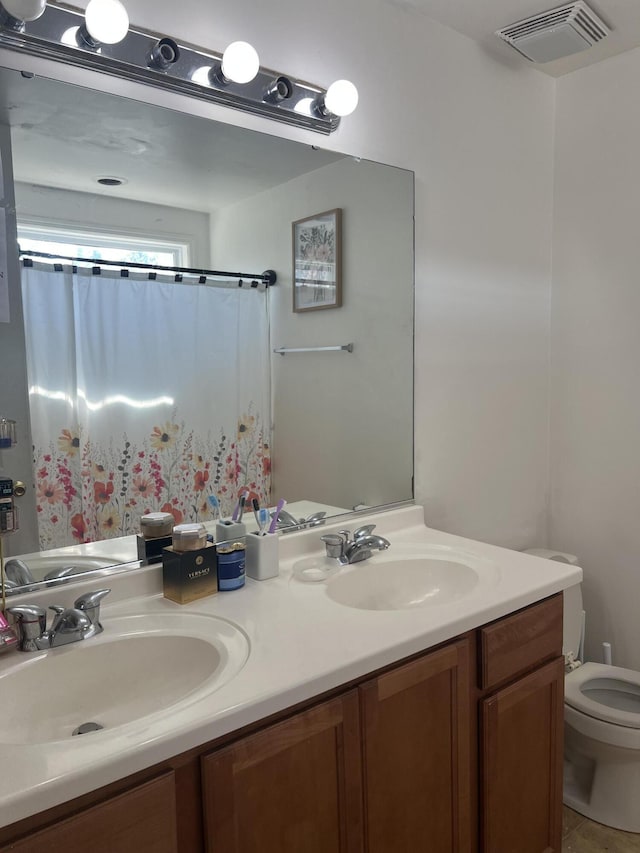 bathroom with vanity and toilet