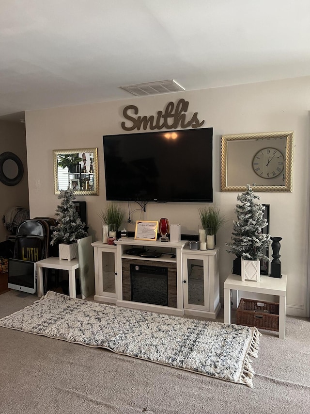 living room featuring a fireplace and carpet flooring