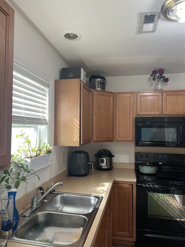 kitchen featuring sink and black appliances