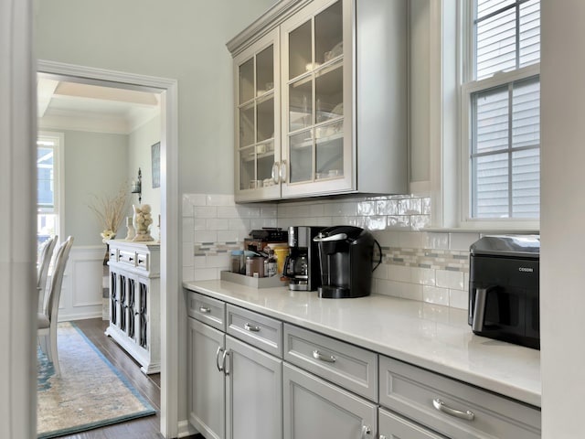 116 Rouen Ln, Summerville, SC 29486 - kitchen with backsplash, ornamental molding, dark wood-style floors, and glass insert cabinets