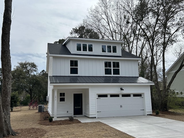 view of front facade featuring driveway, an attached garage, board and batten siding, and central AC