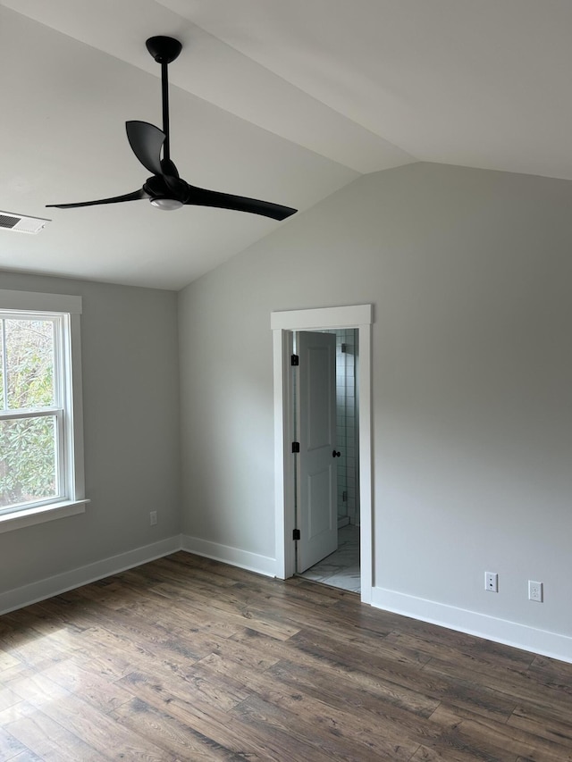 unfurnished room with baseboards, dark wood finished floors, a ceiling fan, and vaulted ceiling