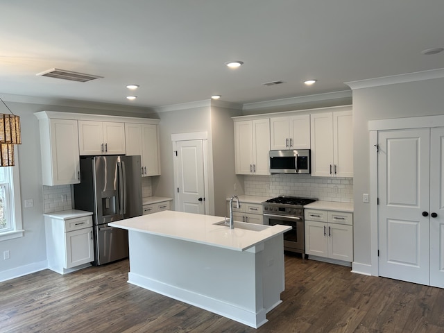 kitchen with crown molding, visible vents, appliances with stainless steel finishes, and a sink