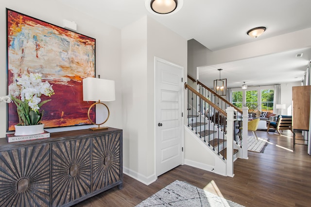 entrance foyer featuring dark hardwood / wood-style flooring and an inviting chandelier