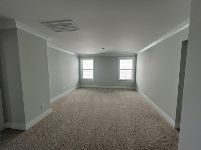 carpeted spare room with crown molding