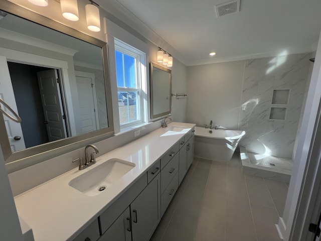 bathroom with tile patterned flooring, vanity, a bathtub, and crown molding