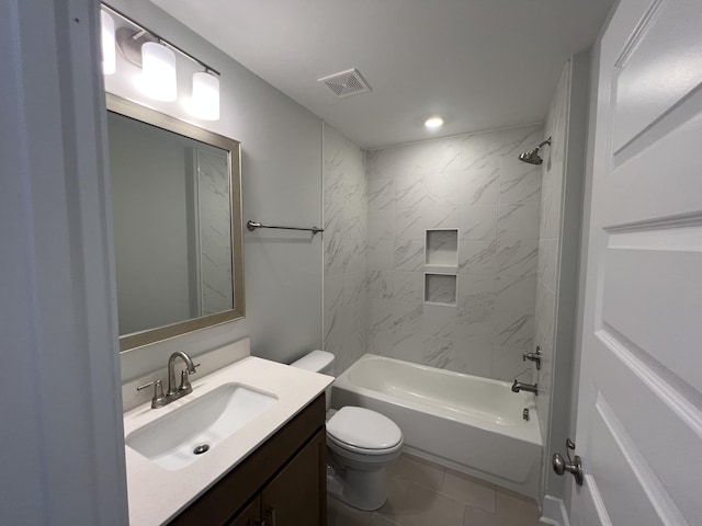 full bathroom with tile patterned floors, toilet, vanity, and tiled shower / bath combo