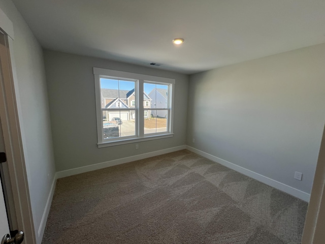 unfurnished room featuring carpet