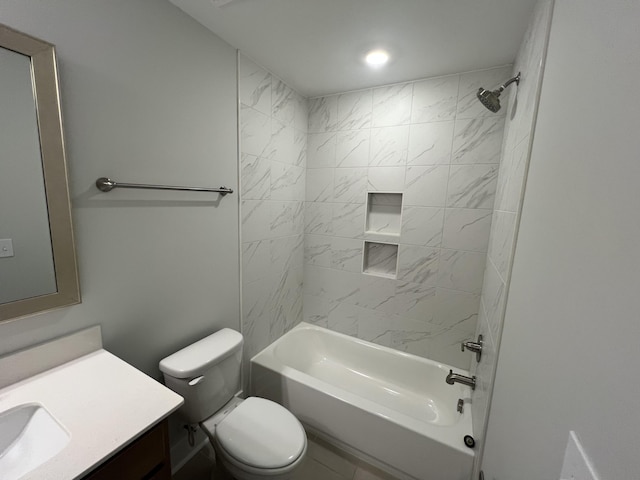 full bathroom with toilet, vanity, and tiled shower / bath