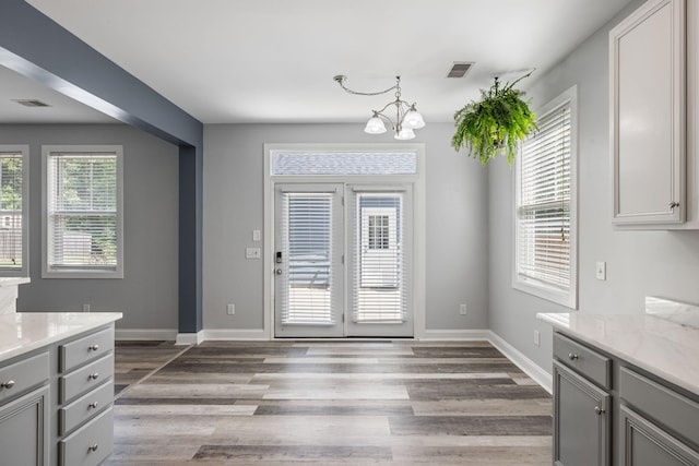 1070 Moss Grove Dr, Moncks Corner, SC 29461 - unfurnished dining area with a chandelier and light wood-style flooring