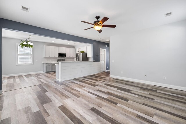 1070 Moss Grove Dr, Moncks Corner, SC 29461 - unfurnished living room featuring ceiling fan, light wood-style floors, and recessed lighting
