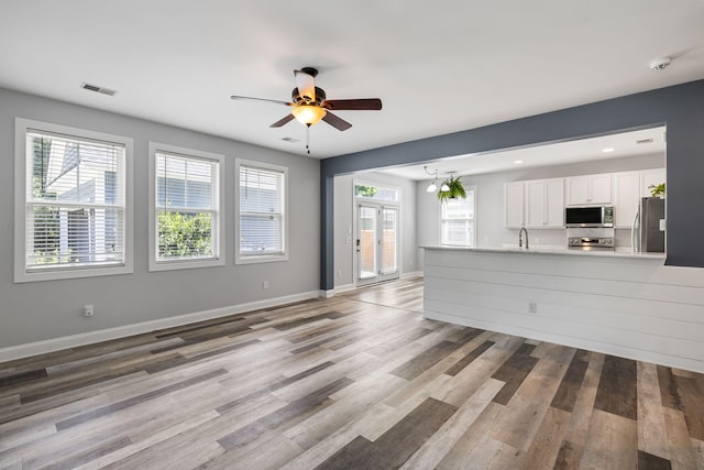 1070 Moss Grove Dr, Moncks Corner, SC 29461 - unfurnished living room featuring a ceiling fan and wood finished floors