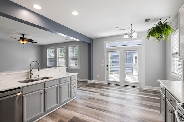 1070 Moss Grove Dr, Moncks Corner, SC 29461 - kitchen featuring dishwasher, gray cabinetry, light wood-type flooring, a ceiling fan, and a chandelier