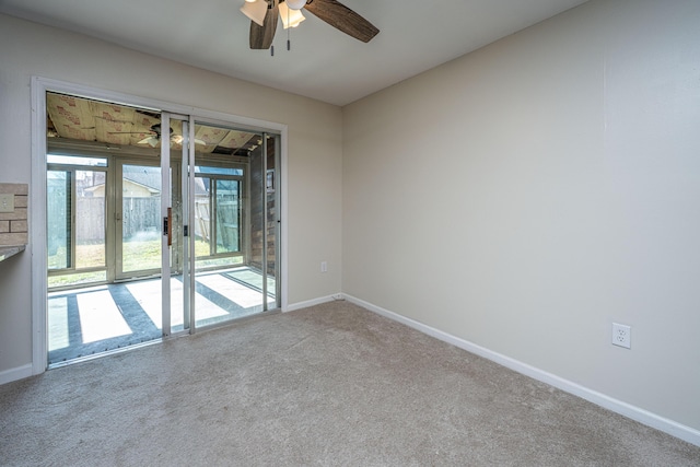 carpeted empty room with baseboards and a ceiling fan