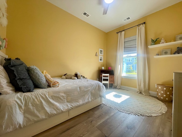 bedroom with ceiling fan and hardwood / wood-style flooring