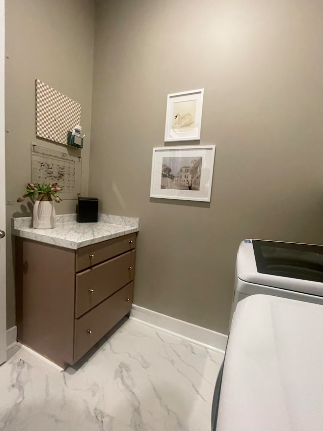 interior space featuring vanity and toilet