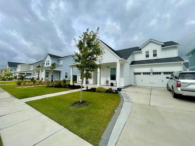 view of front of house featuring a porch, a garage, and a front yard