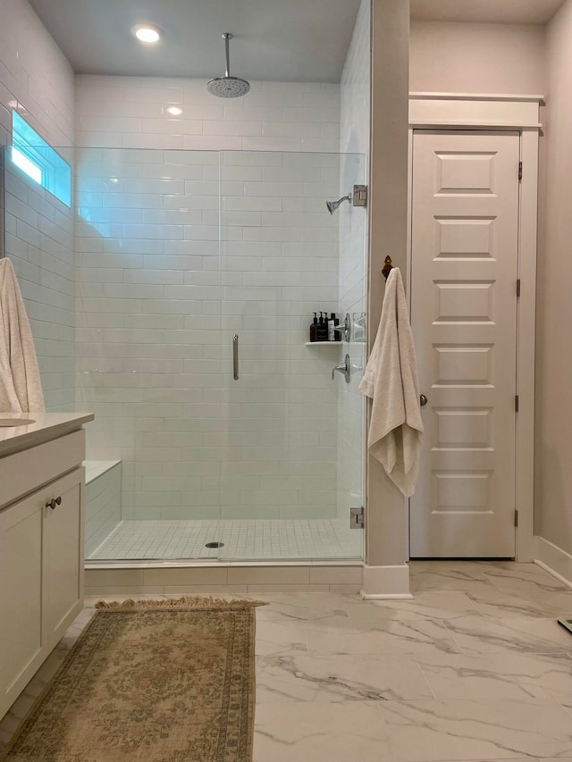 bathroom with vanity and a shower with shower door