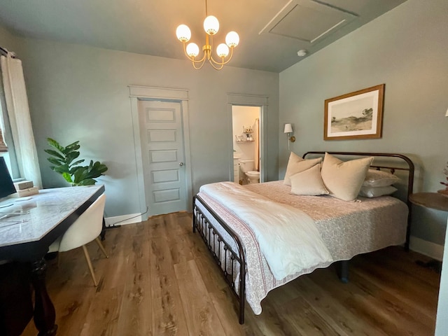 bedroom with ensuite bath and hardwood / wood-style flooring