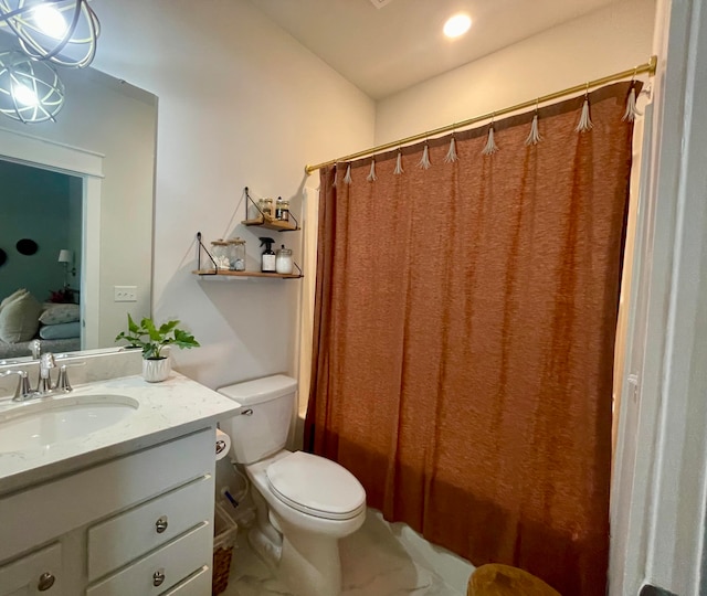 bathroom featuring a shower with curtain, vanity, and toilet