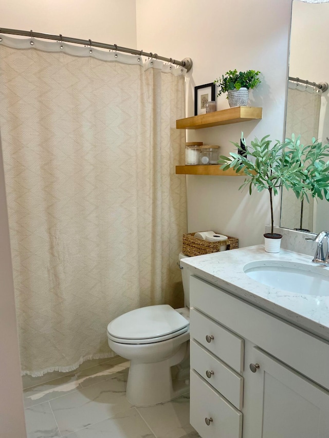 bathroom with vanity, toilet, and curtained shower