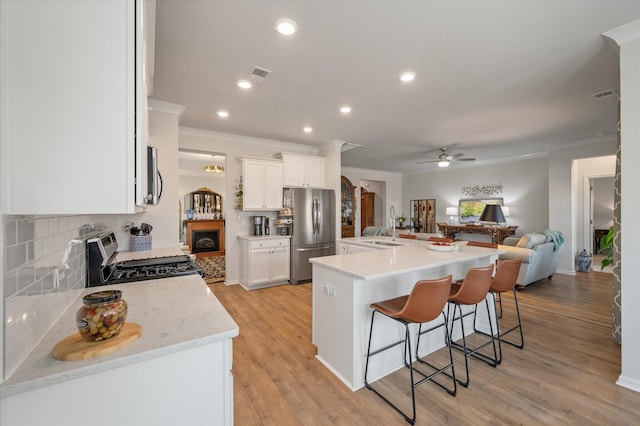 143 Daniels Creek Cir, Goose Creek, SC 29445 - kitchen featuring stainless steel appliances, a ceiling fan, open floor plan, backsplash, and crown molding