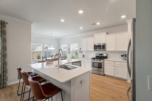143 Daniels Creek Cir, Goose Creek, SC 29445 - kitchen featuring appliances with stainless steel finishes, a sink, a center island with sink, ornamental molding, and tasteful backsplash