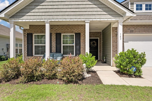 143 Daniels Creek Cir, Goose Creek, SC 29445 - entrance to property with a garage, brick siding, and covered porch