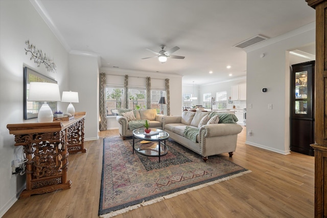 143 Daniels Creek Cir, Goose Creek, SC 29445 - living room with ceiling fan, ornamental molding, baseboards, light wood-type flooring, and recessed lighting