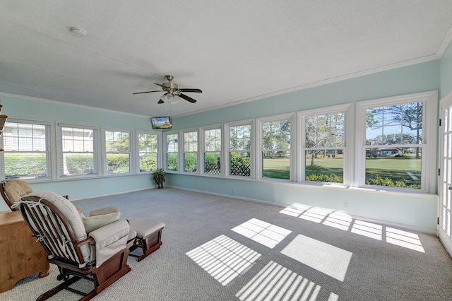 unfurnished sunroom featuring ceiling fan