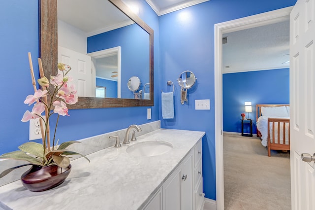 bathroom with crown molding and vanity