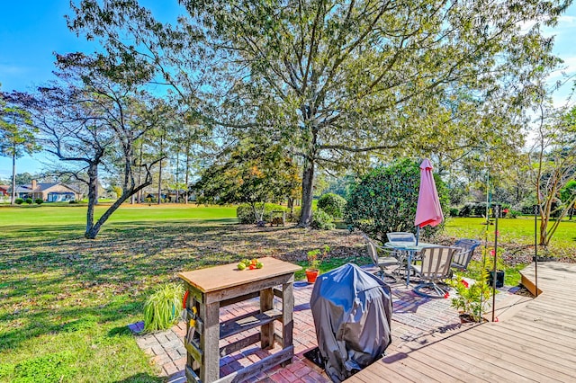 wooden terrace with a lawn