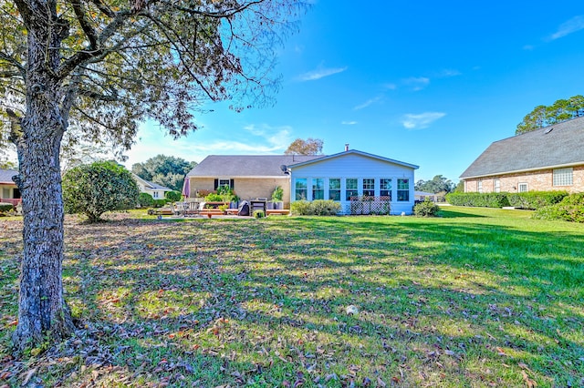 back of house with a lawn