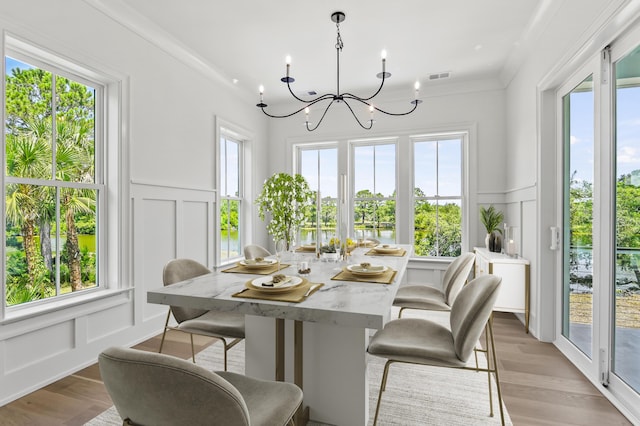 sunroom / solarium with a chandelier