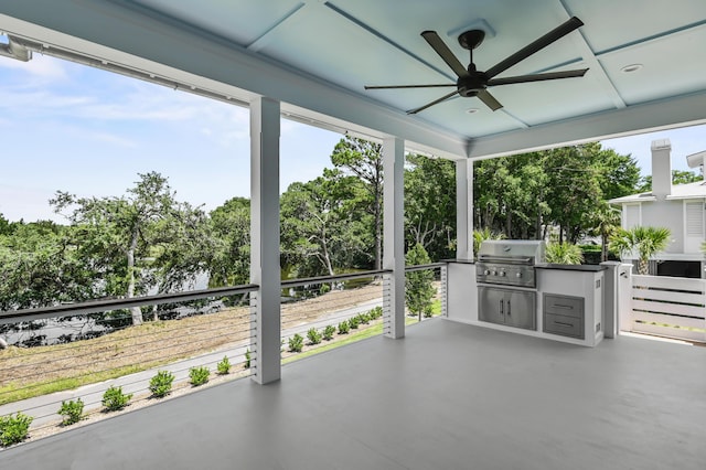 view of patio with area for grilling, ceiling fan, and an outdoor kitchen