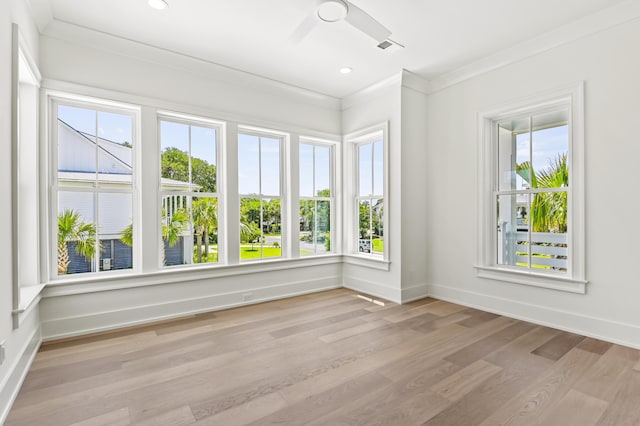 unfurnished sunroom featuring ceiling fan