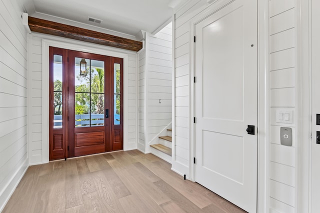 entryway featuring wooden walls and light hardwood / wood-style flooring