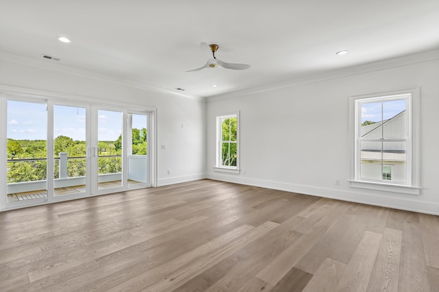 empty room featuring ceiling fan, ornamental molding, and light wood-type flooring