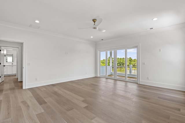 empty room featuring crown molding, ceiling fan, and light wood-type flooring