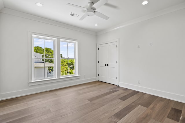 unfurnished room with crown molding, ceiling fan, and light wood-type flooring