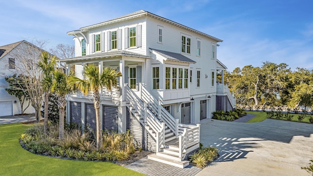 raised beach house featuring a porch