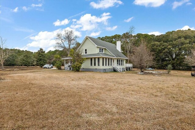 4689 Causey Pond Rd, Awendaw, SC 29429 - view of side of property with a chimney, a yard, and a view of trees