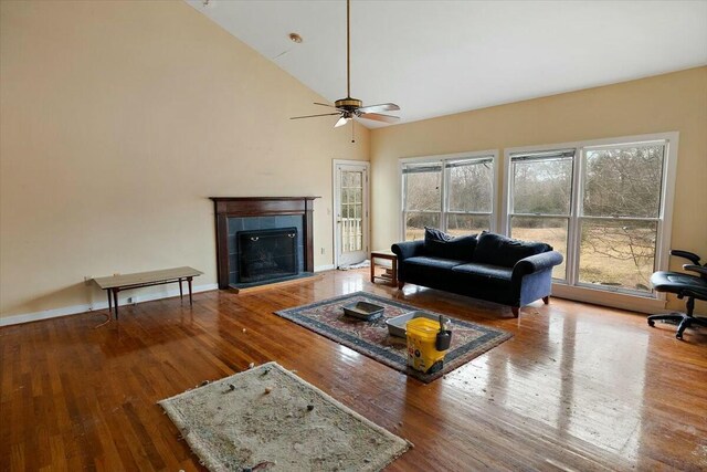 4689 Causey Pond Rd, Awendaw, SC 29429 - living area featuring wood finished floors, a tile fireplace, a ceiling fan, and high vaulted ceiling