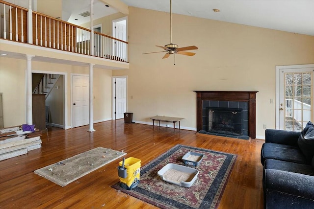 4689 Causey Pond Rd, Awendaw, SC 29429 - living area featuring a ceiling fan, wood finished floors, a tile fireplace, high vaulted ceiling, and baseboards
