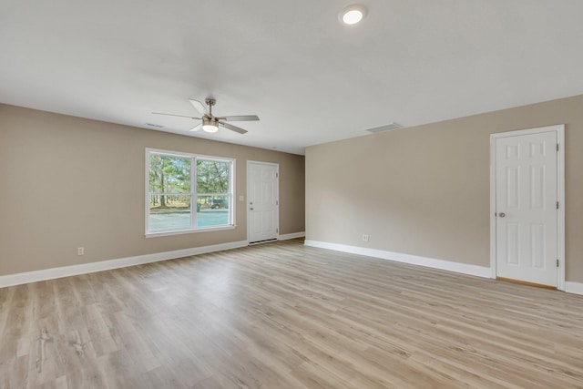 spare room featuring light wood-type flooring and ceiling fan