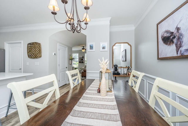 754 Certificate Ct, Charleston, SC 29414 - entrance foyer with ornamental molding, dark wood finished floors, ceiling fan with notable chandelier, a wainscoted wall, and arched walkways