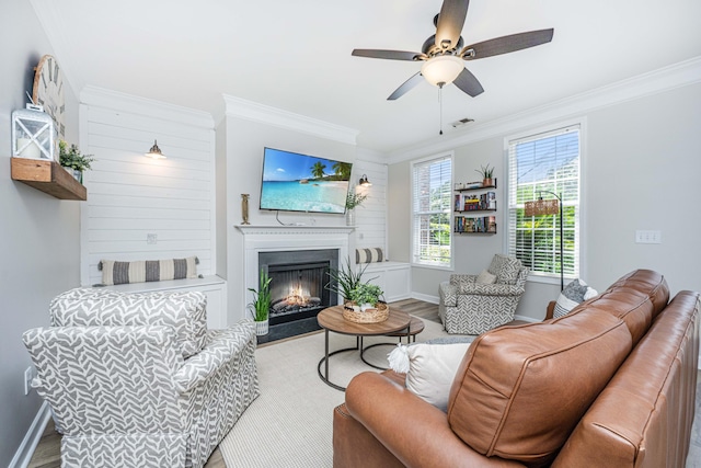 754 Certificate Ct, Charleston, SC 29414 - living room with a warm lit fireplace, wood finished floors, ornamental molding, ceiling fan, and baseboards