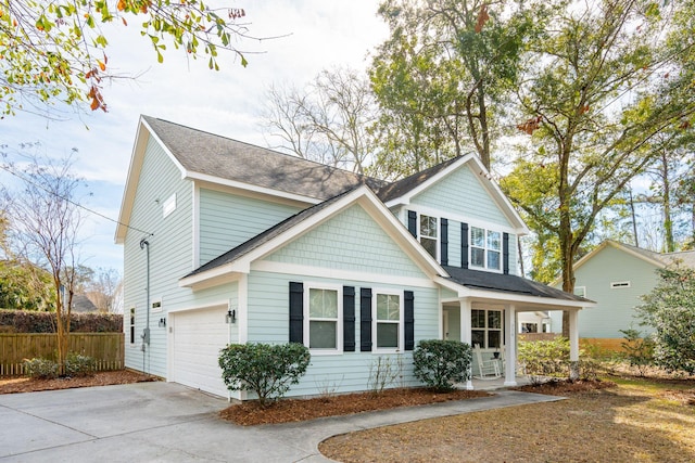 view of front facade with a garage and a porch